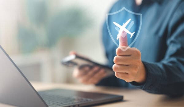 travel, insurance, planning, coverage, medical, cancellation, A traveler shows a digital shield with an airplane icon, symbolizing travel insurance, trip protection, and secure journey planning.